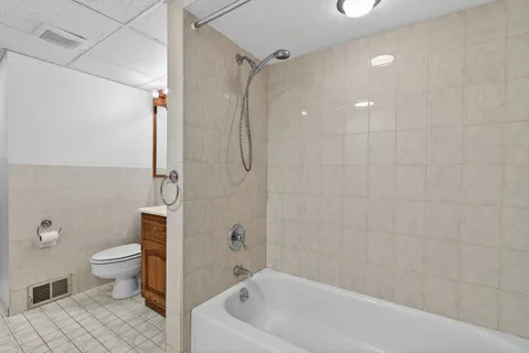 a bathroom with a bathtub and a toilet