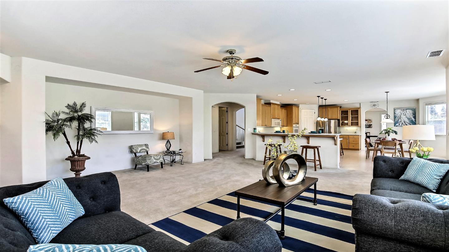 1447 Atlantic Avenue Ripon, CA 95366 - Photo 12 of 25 a living room with furniture a fireplace and a chandelier