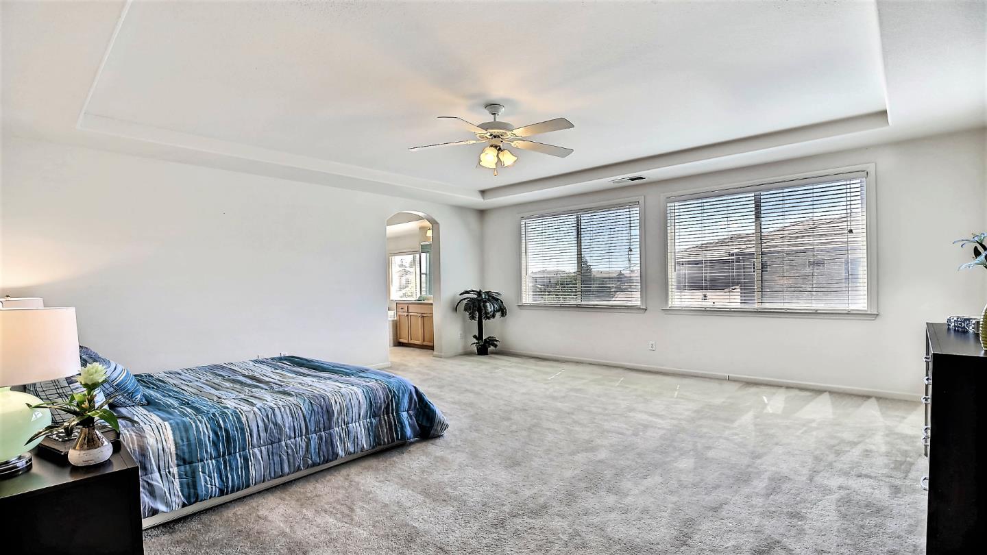 1447 Atlantic Avenue Ripon, CA 95366 - Photo 19 of 25 a spacious bedroom with a bed and a large window with outer view
