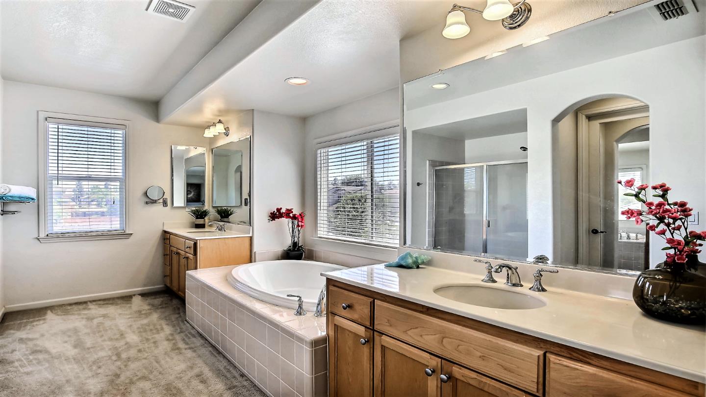 1447 Atlantic Avenue Ripon, CA 95366 - Photo 20 of 25 a spacious bathroom with a double vanity sink a mirror and a bathtub