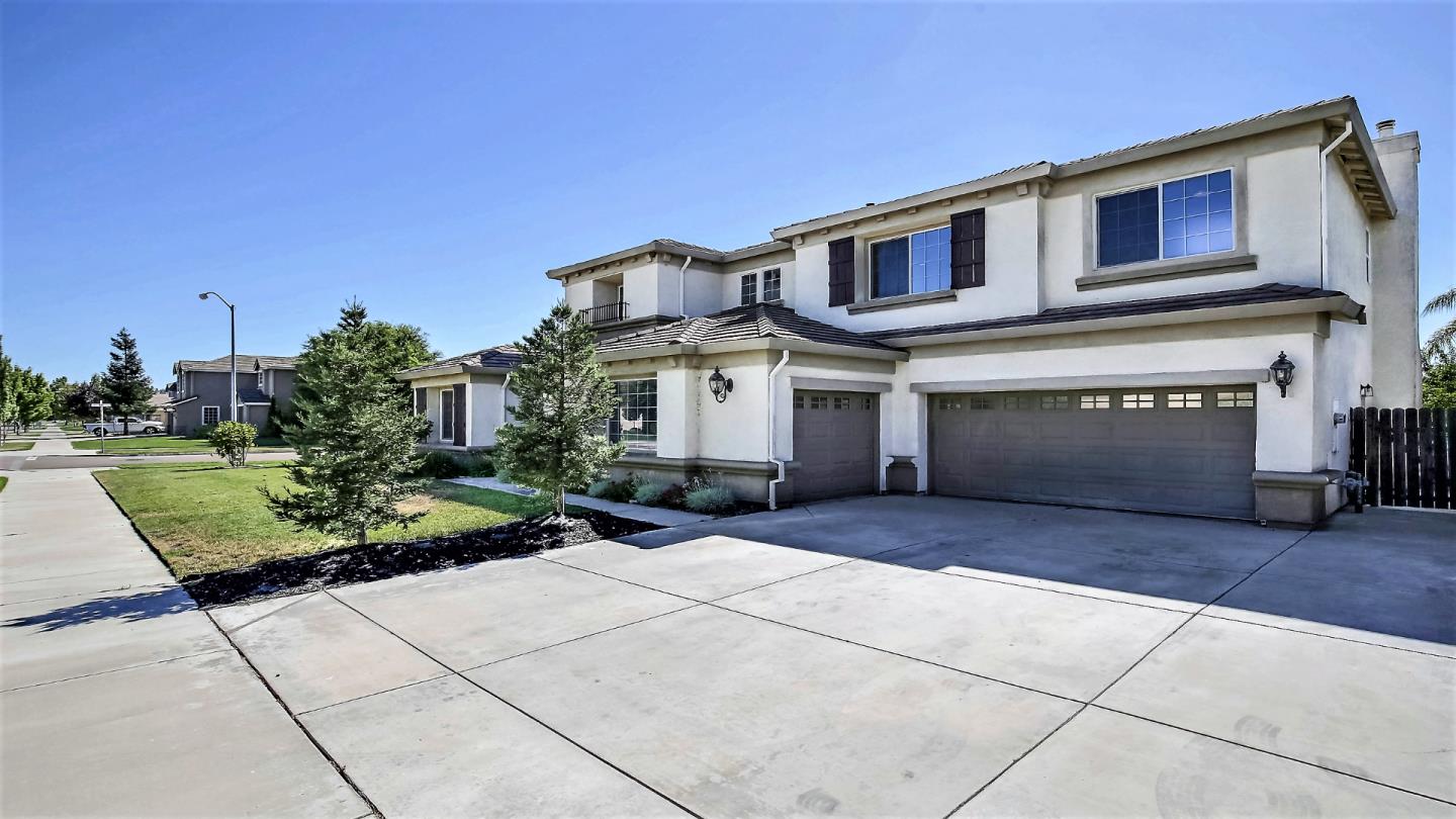 1447 Atlantic Avenue Ripon, CA 95366 - Photo 3 of 25 a front view of a house with a yard and garage