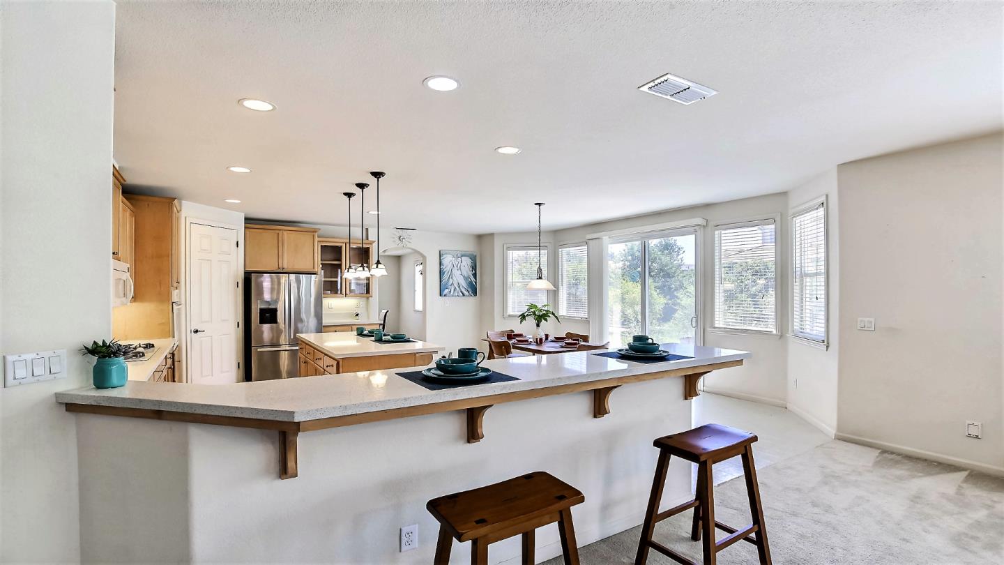 1447 Atlantic Avenue Ripon, CA 95366 - Photo 9 of 25 a room with stainless steel appliances kitchen island granite countertop a sink and cabinets