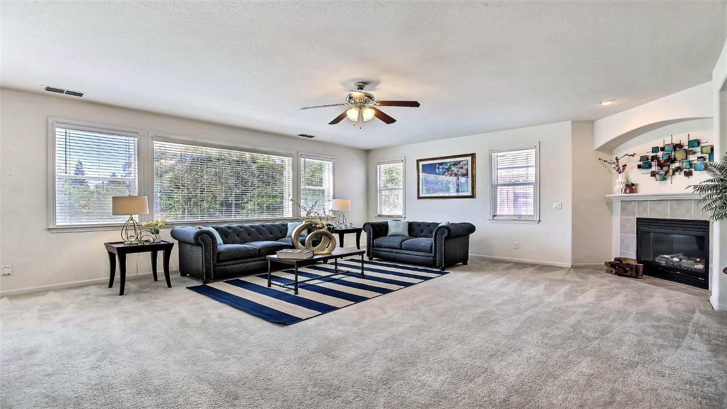 1447 Atlantic Avenue Ripon, CA 95366 - Photo 10 of 25 a living room with furniture and a fireplace