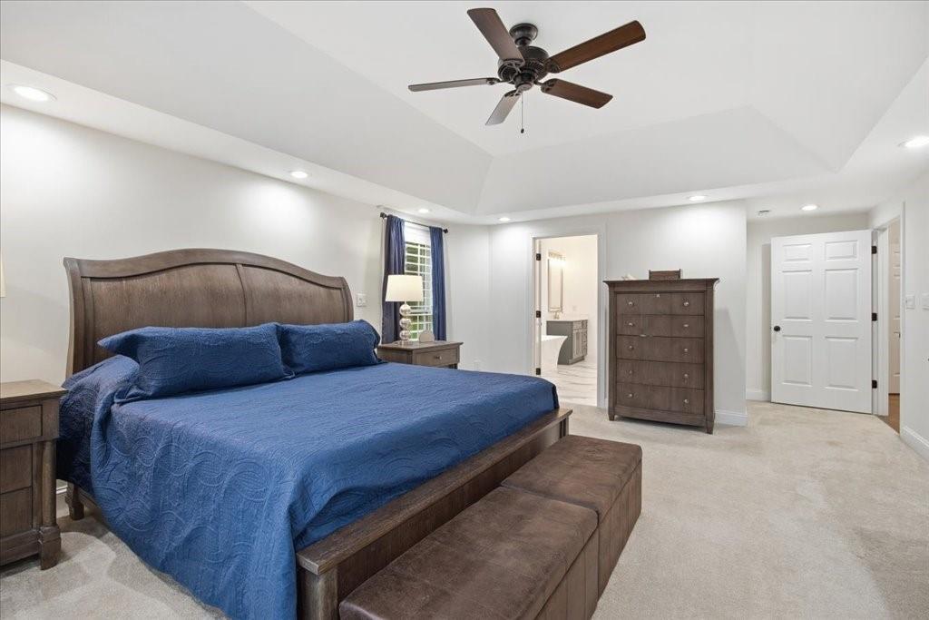 397 Thomas Road Dallas, GA 30132 - Photo 36 of 108 a bedroom with a bed a ceiling fan and a dresser