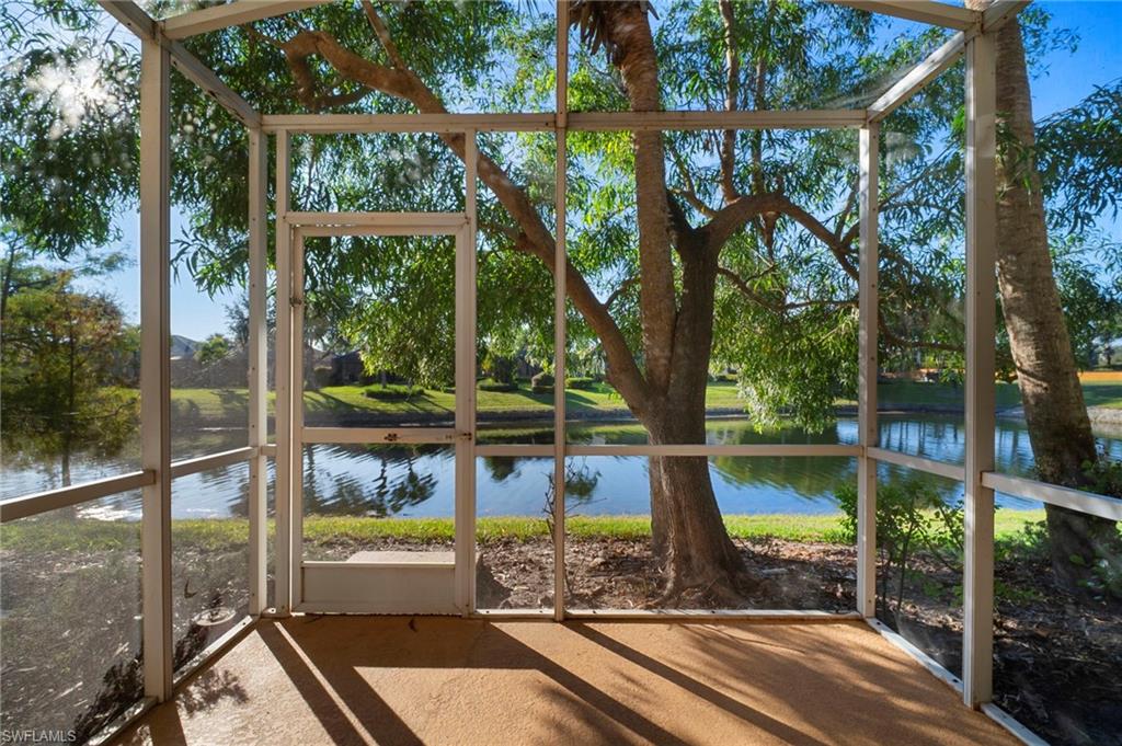 a view of a balcony with floor to ceiling window next to a yard
