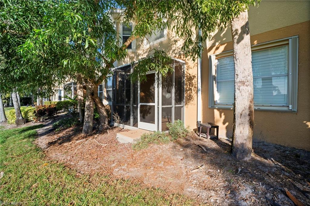 20000 Heatherstone Way, Unit 2 Estero, FL 33928 - Photo 18 of 20 a view of a house with backyard outdoor and garden