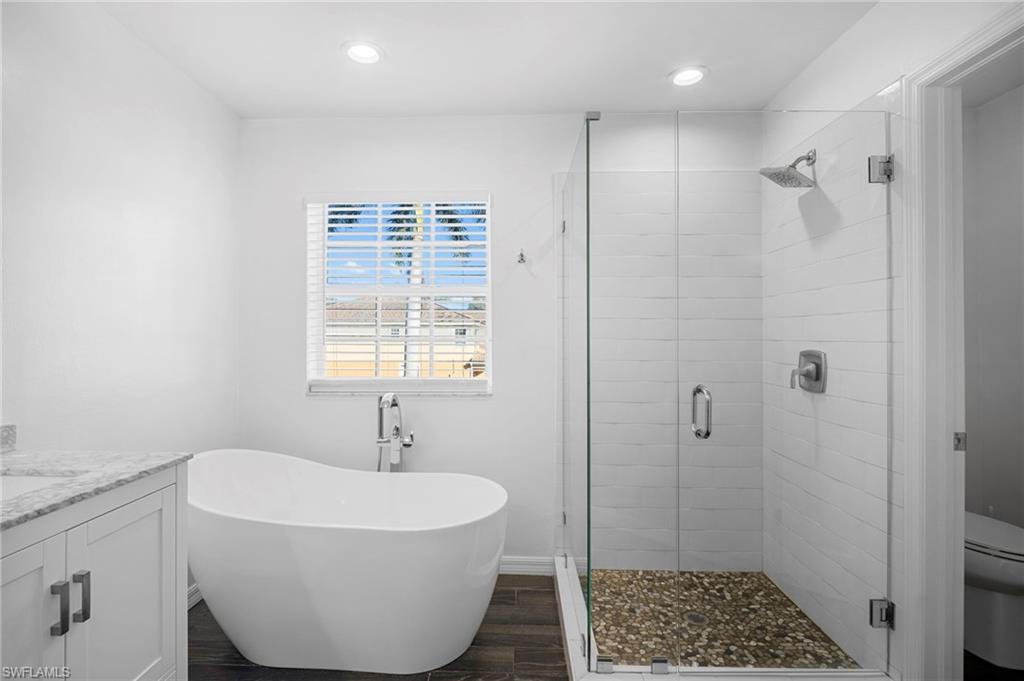 20000 Heatherstone Way, Unit 2 Estero, FL 33928 - Photo 3 of 20 a bathroom with a sink and a shower