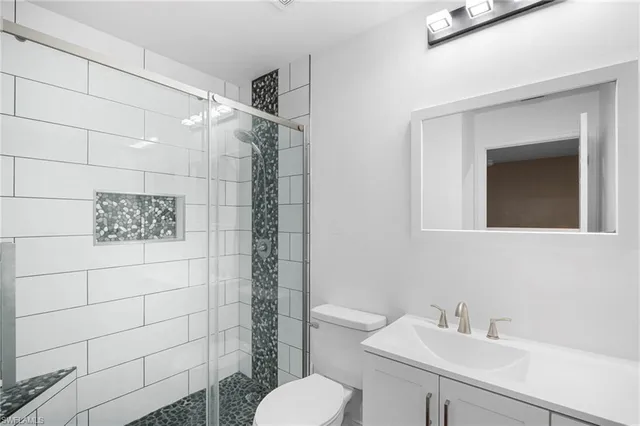 a bathroom with a sink mirror and toilet