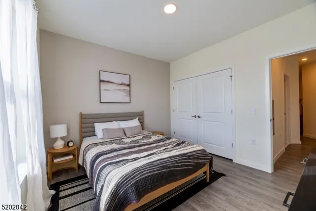 a bedroom with a bed and a painting on the wall