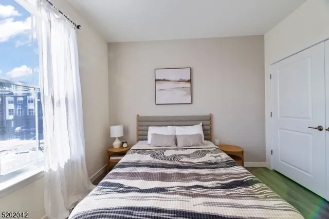 a bedroom with a bed and wooden floor