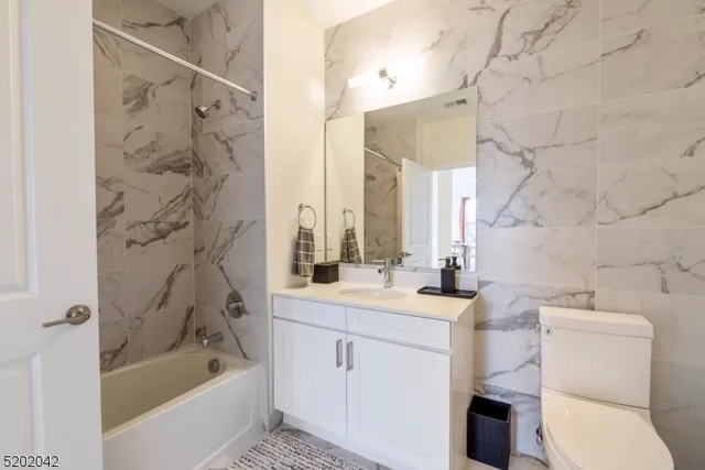a bathroom with a sink toilet tub and shower
