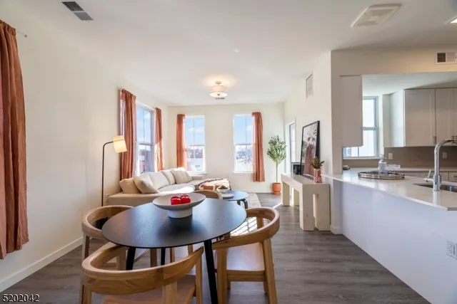 a view of a a dining room with furniture window and wooden floor