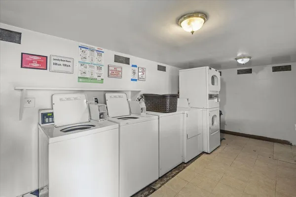 a view of a storage & utility room with refrigerator a washer