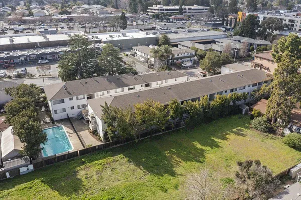 an aerial view of residential houses with outdoor space
