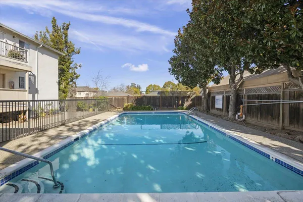 a view of a swimming pool with a yard