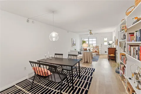 a dining room with furniture and wooden floor