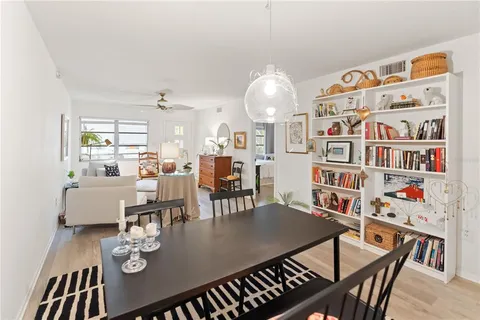 a living room with furniture and a book shelf