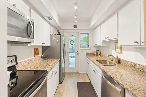 a kitchen with a sink stove and refrigerator
