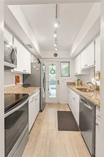 a large kitchen with a stove cabinets and stainless steel appliances