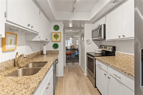 a kitchen with stainless steel appliances granite countertop a sink and stove