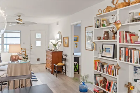 a living room with lots of furniture and a book shelf