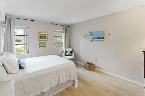 a bedroom with a bed and painting on the wall