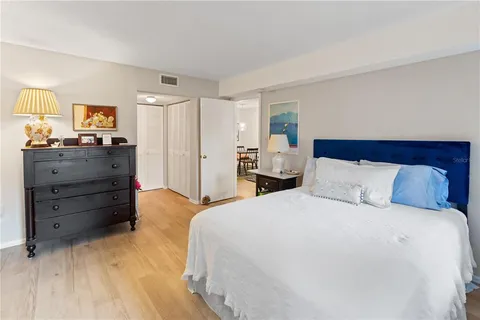 a bedroom with a bed and a mirror