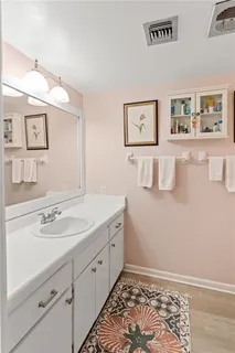 a spacious bathroom with a sink and a mirror