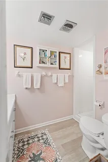 a bathroom with a toilet and a shower