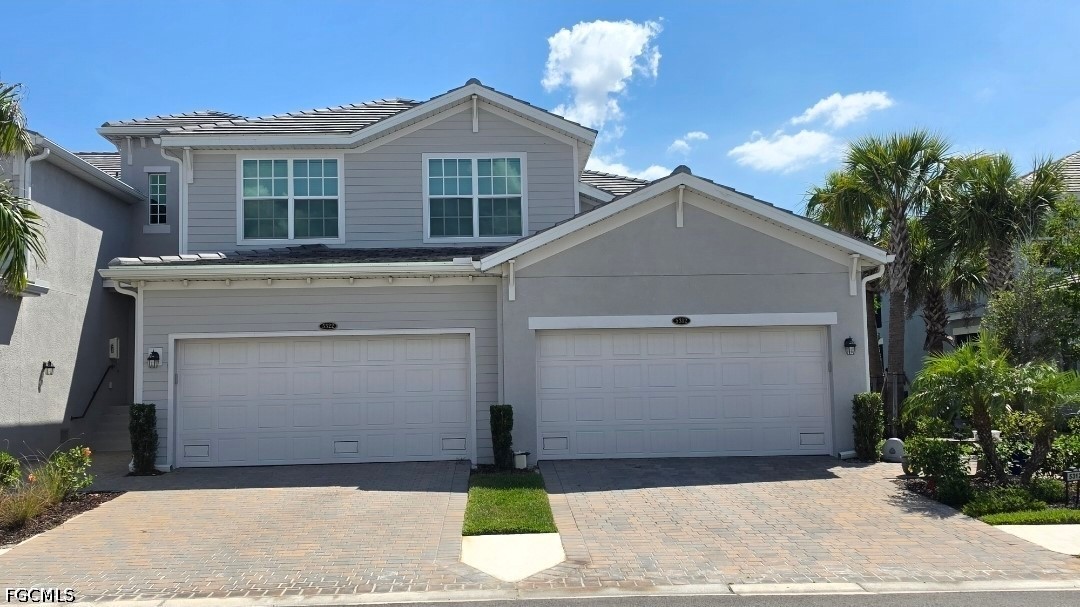 14191 Poppy Fld Loop, Unit 5312 Punta Gorda, FL 33955 - Photo 2 of 41 a front view of a house with a yard and garage