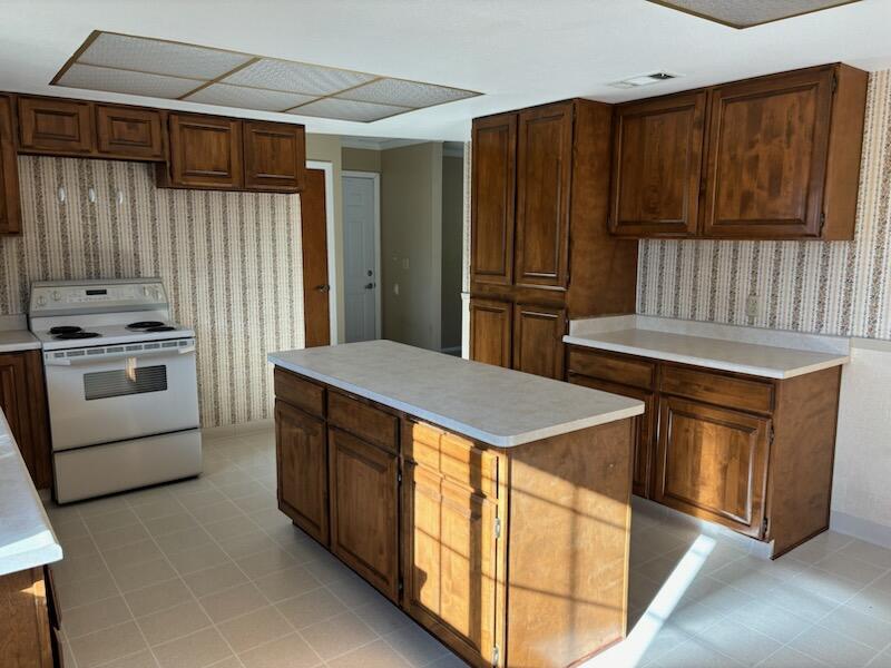 1862 Whaley Road Redding, CA 96003 - Photo 8 of 12 a kitchen with stainless steel appliances wooden cabinets a stove and a refrigerator