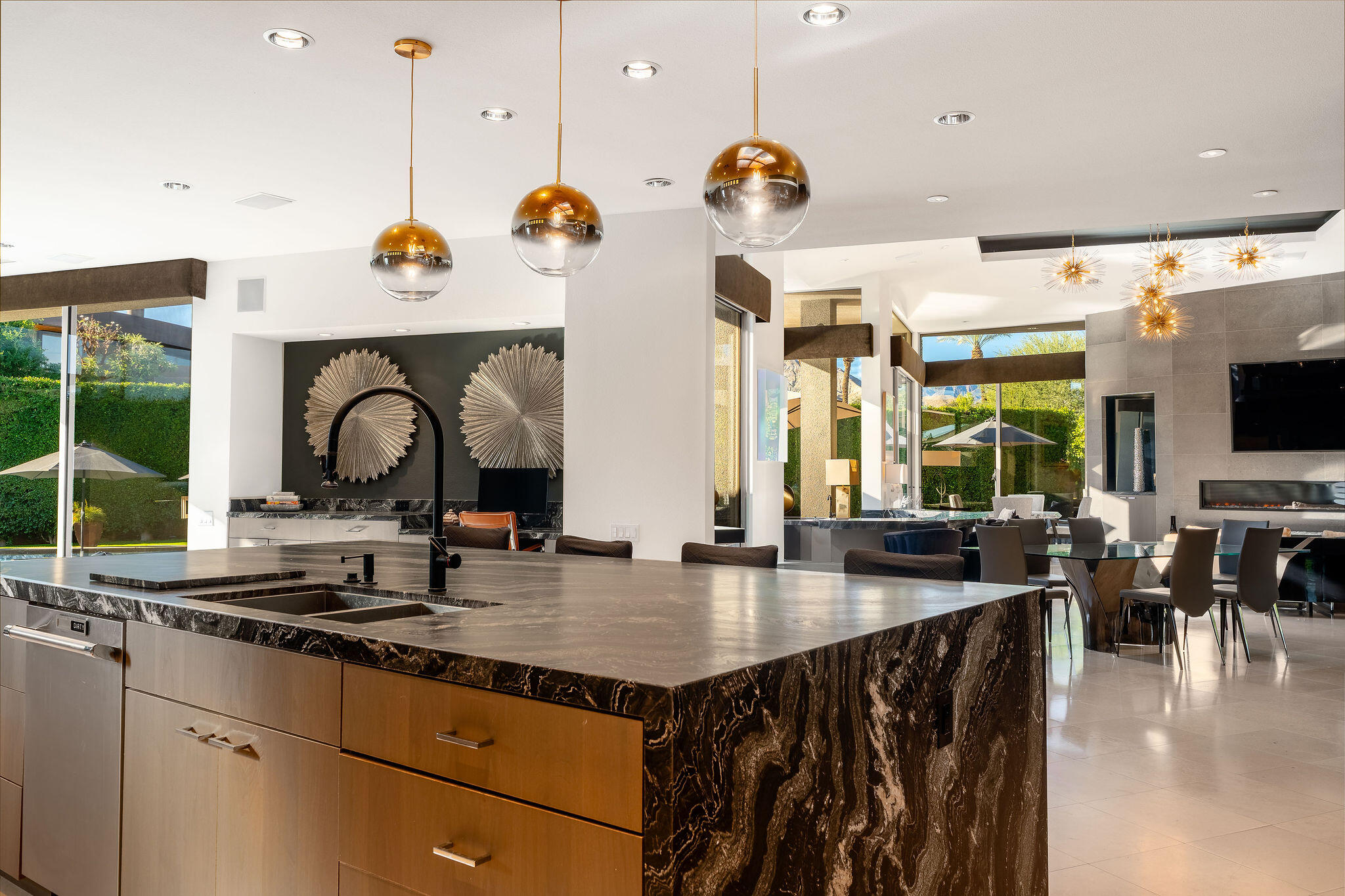 108 Waterford Circle Rancho Mirage, CA 92270 - Photo 12 of 41 a kitchen with stainless steel appliances granite countertop a stove a sink and a dining table with wooden floor