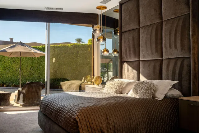 a bedroom with a bed a table and chair