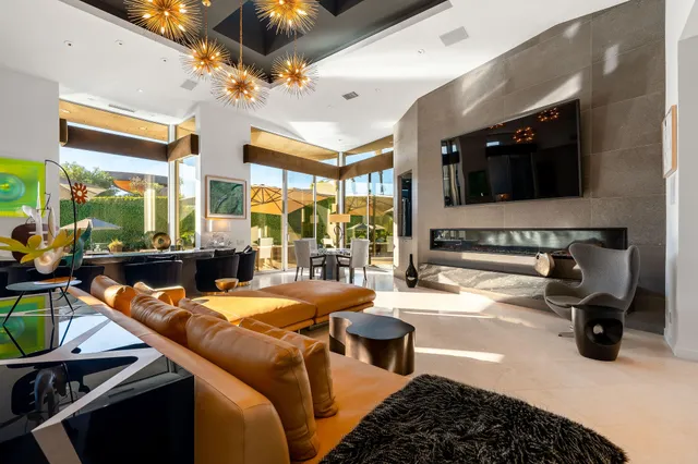 a dining room with furniture and a large window