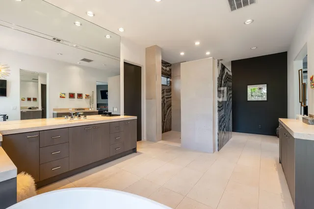 a large room with a large window and stainless steel appliances
