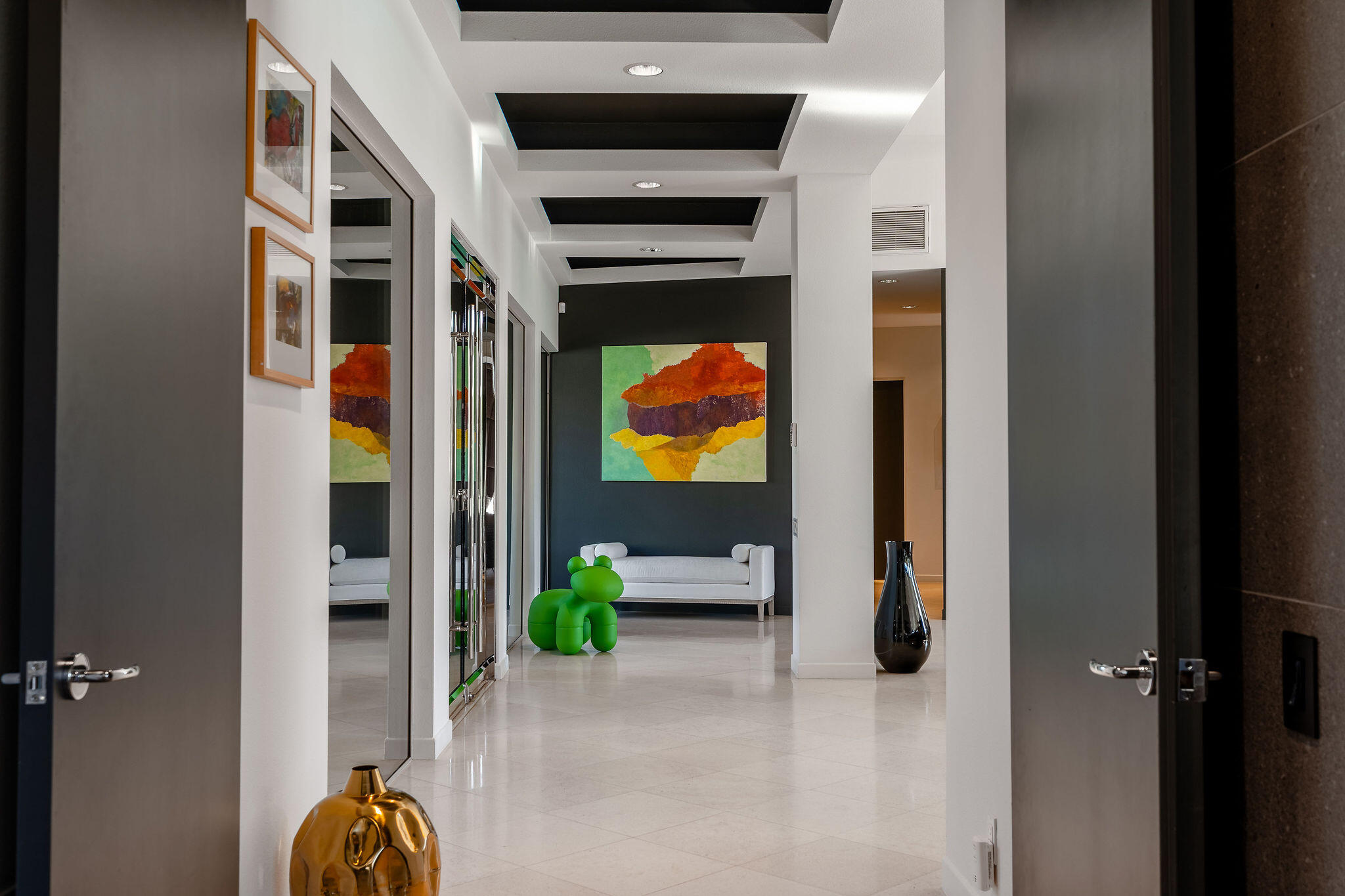 108 Waterford Circle Rancho Mirage, CA 92270 - Photo 25 of 41 a hallway with two couches and a potted plant on it