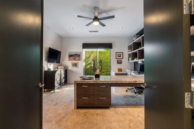 a room with kitchen island stainless steel appliances a sink stove and refrigerator