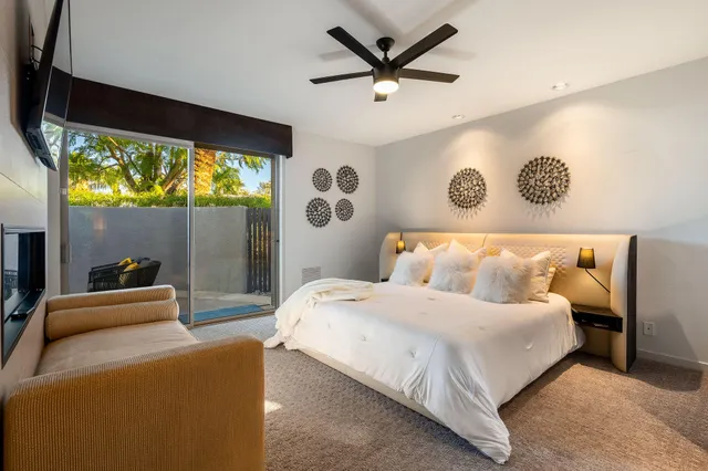 a bedroom with a bed and a large window