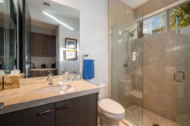 a bathroom with a sink toilet and shower