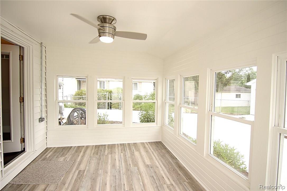 931 West 3rd Street Rochester, MI 48307 - Photo 59 of 62 Three season porch overlooks spacious yard and has new laminate flooring.