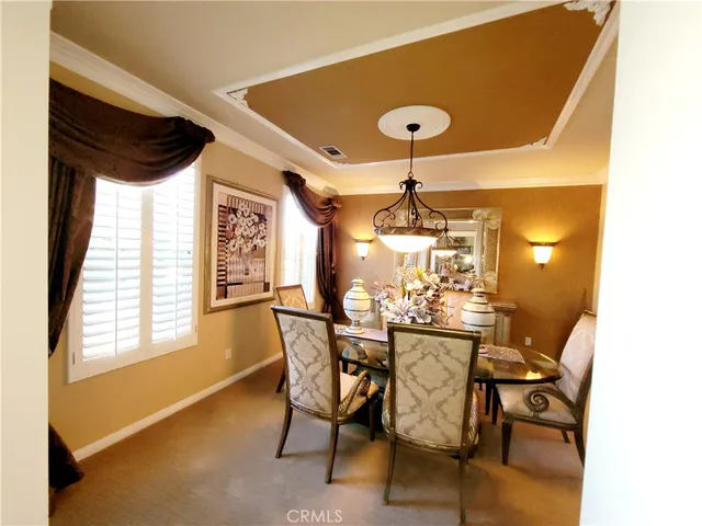 a view of a dining room with furniture and window