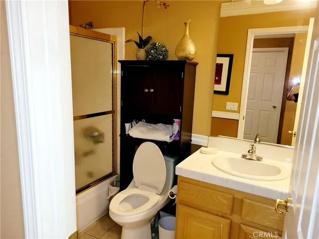 a bathroom with a sink toilet and mirror