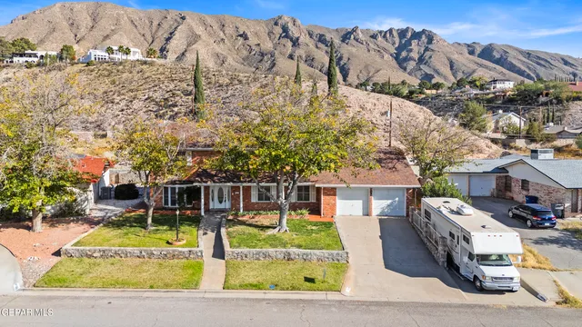 a view of a house with swimming pool and sitting area
