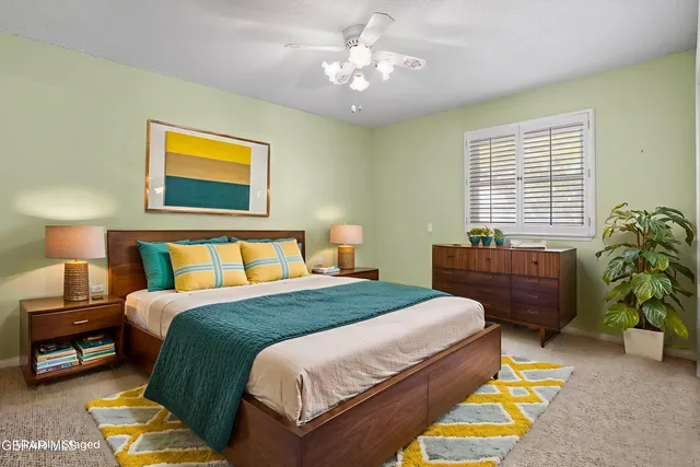 a bedroom with a bed and a potted plant