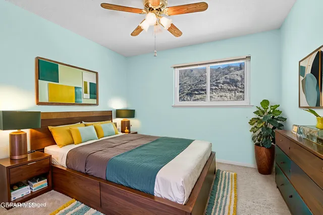 a view of a hallway with wooden floor and mirror