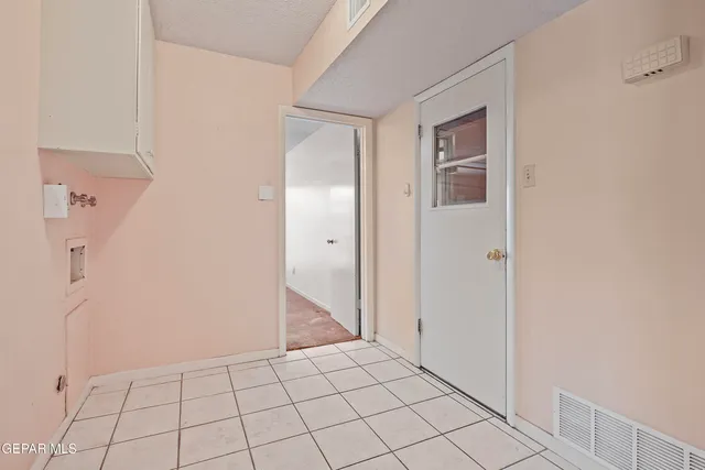 an empty room with a window and a ceiling fan