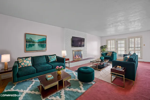 a living room with furniture a flat screen tv and a window