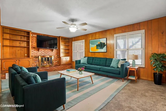 a living room with furniture and a book shelf