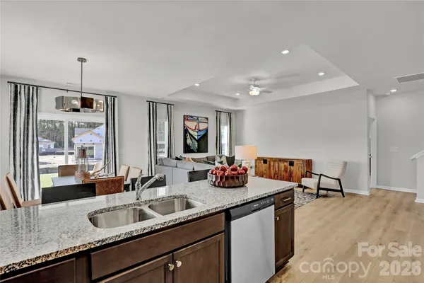 a kitchen with sink and view of living room