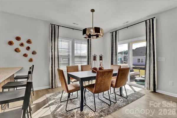 a dining room with furniture and window